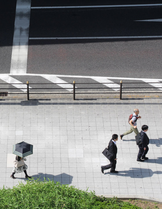 Overhead photo of business people walking on the sidewalk